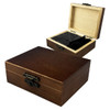 A wooden box with a clasp, containing black stone whiskey ice cubes inside a compartment.