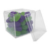 A clear cube container filled with green and purple jelly beans, partially open.