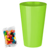 A bright green cup next to a packet of assorted jelly beans in various colours.
