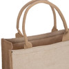 A tan and beige reusable grocery bag with two sturdy handles and a simple design. It features a logo.