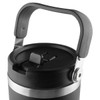A travel mug with a black body, silver band, and a sturdy handle. It features a secure lid and a branding logo.