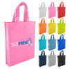 A pink non-woven tote bag with two handles and a logo, alongside bags in various colours including red, yellow, and blue.