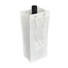 A drink bottle is placed inside a white non-woven single bottle bag with a drawstring. The bag has a simple design and a logo.