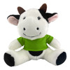 A plush cow toy with a black and white exterior, wearing a green shirt, smiling softly.