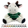 A plush cow toy with black and white fur, wearing a green shirt and featuring a logo. Various small cow figures are in the background.