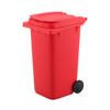 A red wheelie bin pen holder with a closed lid and a black wheel, designed for desk organisation.
