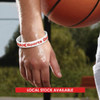 A silicone wristband in white with red details, worn on a hand holding a basketball.