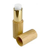 A bamboo lip balm stick with a white balm tip and a gold-toned cap, featuring a natural bamboo exterior.