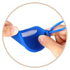 A blue silicone luggage tag being held, showcasing its flexible design and transparent window for identification.