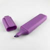 A purple highlighter with a chisel tip, accompanied by its matching cap.