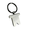 A silver keyring shaped like a small man, attached to a metal ring. The keyring has a shiny, smooth finish.