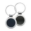 A silver key ring with a circular design featuring a dark, mirror-like surface on one side and a plain surface on the other.