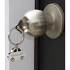 A silver key ring shaped like a car hangs from a door knob, featuring a logo.