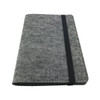 A grey felt notebook with a black elastic band, featuring a minimalistic design and a logo.