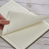 A5 wood look notebook featuring lined pages, held open to display the interior. Soft texture in earthy tones.