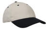 A cap featuring a cream body and a black brim, designed with ventilation holes and a logo.