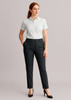 A pair of women's bandless elastic waist pants in dark grey, styled with a white shirt and black heels.