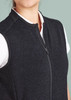 A black zip front vest featuring a high collar and a fitted design, with a white shirt underneath.