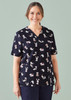 A navy scrub top featuring various printed cartoon animals. The top has a V-neck design and a logo on the sleeve.