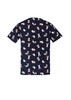 A navy scrub top featuring a whimsical print of animals and flowers, with a logo on the fabric.
