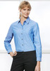 A women's long sleeve chambray shirt in light blue with a button-up front and a chest pocket.