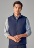 A navy unisex reversible fleece vest with a zip front and a logo on the chest, modelled by a man.