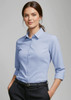 Light blue women's button-up shirt with 3/4 sleeves and a collar, featuring a logo.