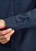 A dark blue long sleeve button-up shirt with a textured cuff and a small pocket on the chest.