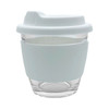 A reusable glass coffee cup in clear and light blue, featuring a silicone sleeve and a fitted lid.