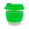 A reusable coffee cup in clear glass with a bright green silicone lid and sleeve, featuring a logo.