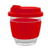 A reusable glass coffee cup with a transparent body and a red silicone band and lid. It features a logo.