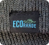 A textured grey beanie featuring a label with branding. The fabric appears to be knitted.