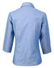 A light blue ladies' chambray shirt with 3/4 sleeves and a classic collar, featuring a logo.