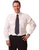 A man wearing a white long sleeve button-up shirt with epaulettes and a striped tie, posing confidently.