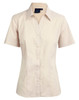 A short sleeve button-up shirt in a light beige colour, featuring a collar and a logo on the tag.