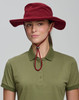 A beige bucket hat with a chin strap and a branded logo, featuring a wide brim for sun protection.