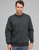 A dark grey crew fleece sweatshirt featuring a round neck and ribbed cuffs, modelled by a man.