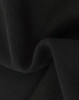 A close-up of soft, black fabric showcasing a textured surface, indicating a fleece material.