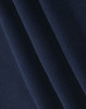 A close-up of soft, dark navy fabric, highlighting its smooth texture and folds.