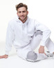 A white fleecy hoodie with a front pocket, featuring a logo, worn with matching light grey pants.