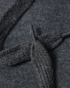 A close-up of a dark grey fleece hoodie showing the texture of the fabric and a knitted drawstring.