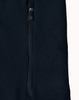A dark navy softshell jacket featuring a zippered pocket and a sleek design. The jacket also has a logo.
