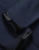 A close-up of a navy softshell hoodie featuring cuff details and a logo.