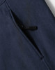 A close-up of a navy blue softshell hoodie featuring a zippered pocket. The fabric has a soft texture.
