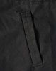 A close-up of a black fabric featuring a stitched pocket on a jacket. The material appears durable and textured.