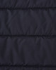 A close-up of a navy blue insulated puffer jacket fabric with a stitched, quilted pattern and a logo.