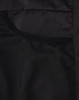 A close-up of the interior of a black insulated puffer jacket, featuring mesh pockets.