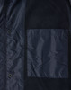 A navy unisex jacket featuring a pocket and snap buttons, made from a mix of materials. It has a logo.