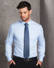 A light blue long-sleeve button-up shirt worn by a man, featuring a pocket and with a tie.