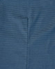 A close-up of a blue pin dot fabric, displaying subtle texture and stitching details typical of a long-sleeved button-up shirt.